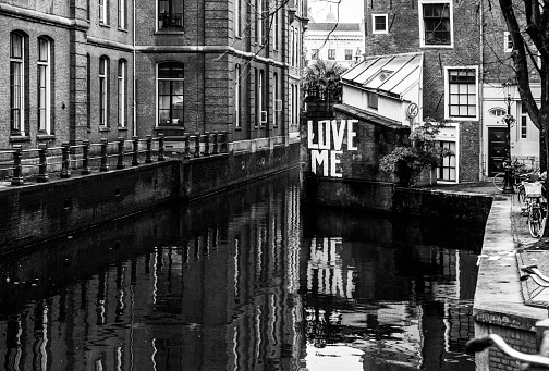 Amsterdam - December 7, 2015: Love me, written in Amsterdam and reflected in the canal water