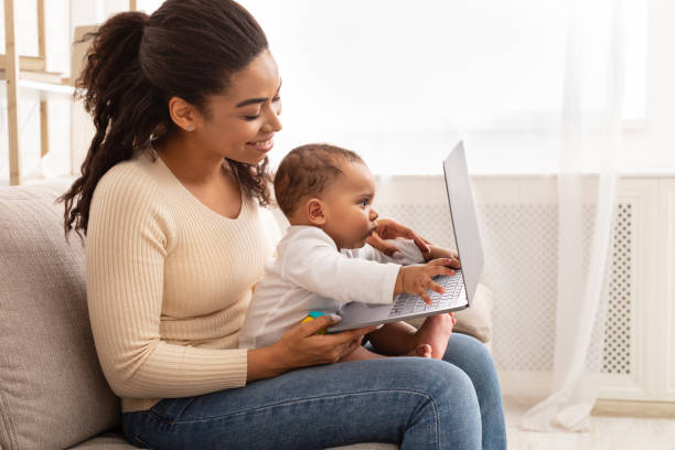 istock Happy Black Mom With Toddler Using Laptop Sitting At Home 1312614800