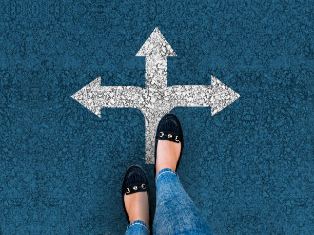 woman legs in shoes standing on road with three direction arrow legs and three direction arrow choices, left, right or move forward crossroad stock pictures, royalty-free photos & images