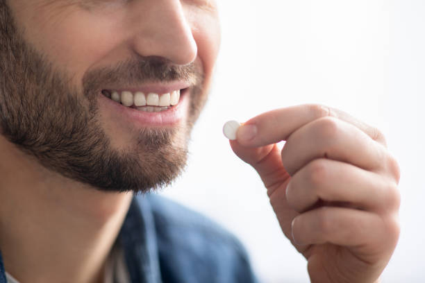 istock Unrecognizable smiling man taking medicine, copy space 1312618174