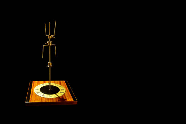 istock Abstract object on black background. Vintage wall clock with a metal rotary mecanism in the centre. 1312622723