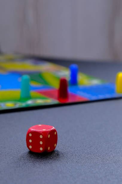 istock Dice for board games on black background. Board game with multi-colored cubes on table game. Stay home leisure activity 1312627865
