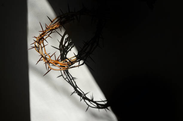 istock Abstract Easter. Crown of thorns and swadow on wall 1312630272