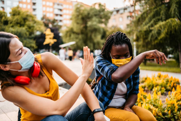 istock Woman with face masks sneezing in elbow 1312632398