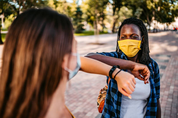 istock Two friends greeting with elbow bump 1312633389