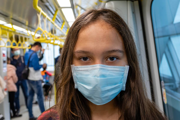 istock Young tween girl wearing surgical mask on subway 1312633479