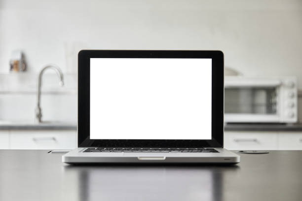 istock Blank screen of laptop on black desk, home kitchen with blurred background 1312634838