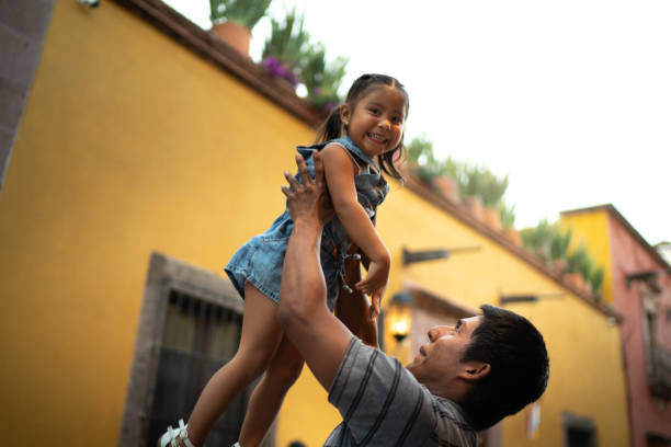 istock Father lifting daughter up in the air 1312635587