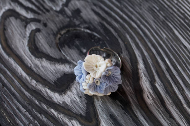 istock Handmade jewelry. Polymer clay ring. Lies on pine boards. 1312635848