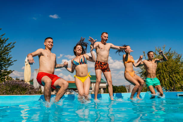 istock Friends jumping in swimming pool 1312636893