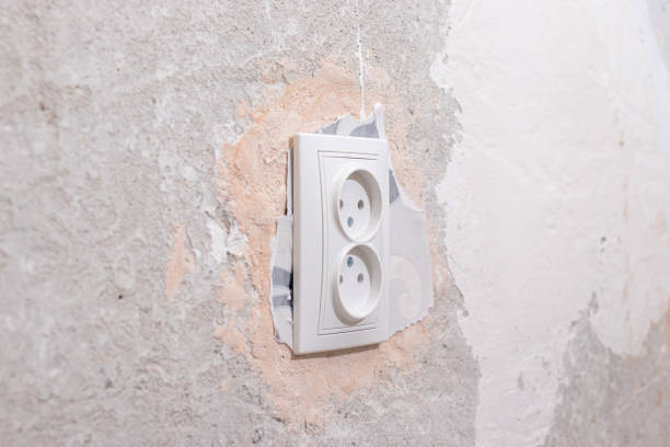 istock Broken wallpaper during repair, remnants of wallpaper under the socket. 1312637220