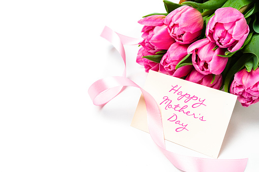 Pink tulips and a card with the text \