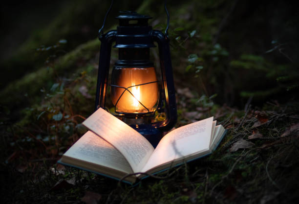 istock A magic kerosene lamp  and the book in the dark forest 1312639162
