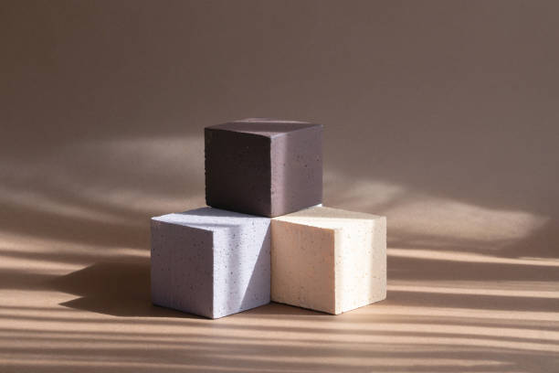 istock 3d podium, for presentations of packaging, cosmetics. Three cubes of different colors, beige, white, brown, in form of staircase on background with shadow from the window. Concept of beauty industry 1312639192