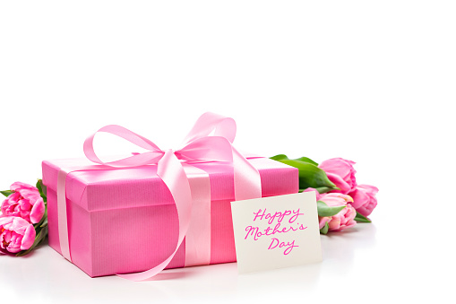 Front view of a pink gift box with a bow and a greeting card with the text