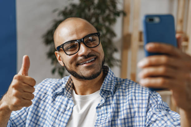 istock Disabled man sitting in a wheelchair and using mobile phone 1312642794