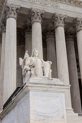 U.S. Supreme Court Building, Washington DC, USA. The Contemplation of Justice statue is in foreground.
.