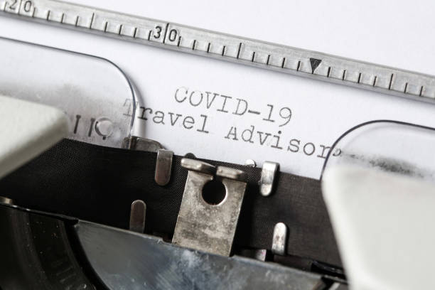 istock COVID-19 Travel Advisor text on blank paper typed on a retro typewriter 1312645248
