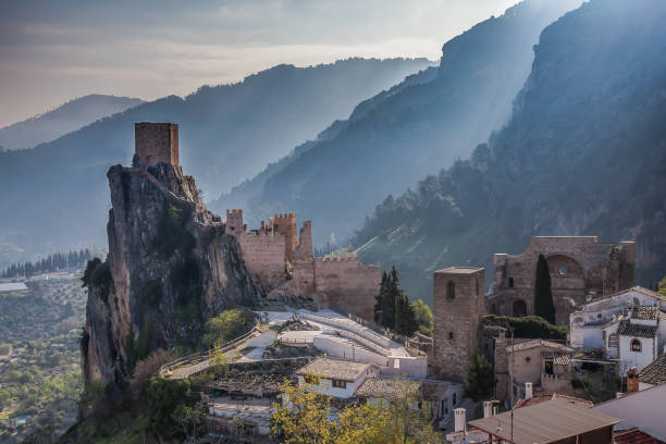 The Iruela Castle, Jaen. Spain Castle in the foreground against the backdrop of mountains with morning sunshine jaen stock pictures, royalty-free photos & images