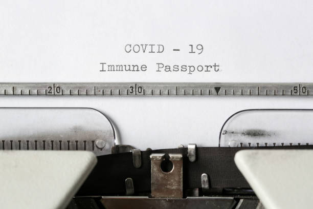 istock COVID -19 Immune Passport text on blank paper typed on a retro typewriter 1312646738