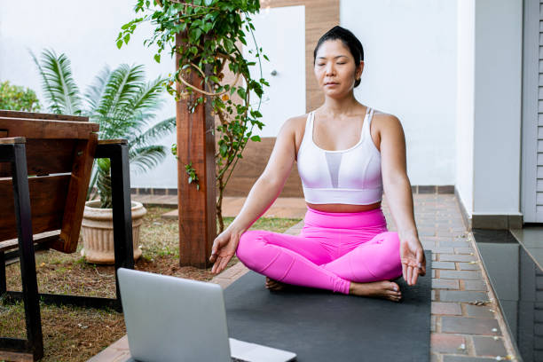 istock Yoga instructor greeting students by video conference 1312647386