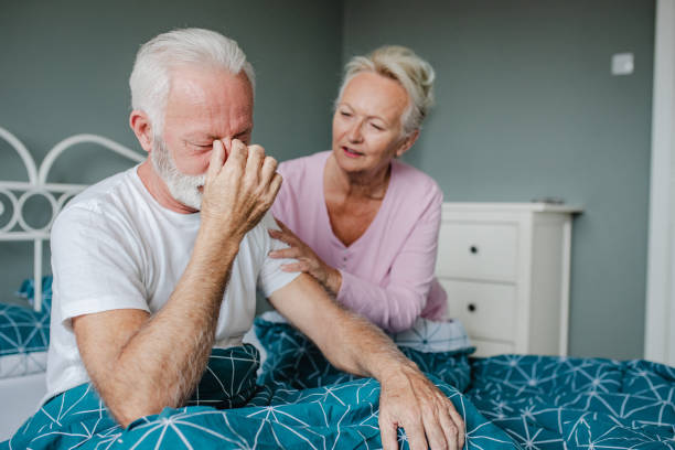 istock Senior man is having headache in bed 1312649424
