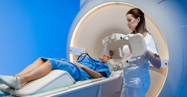 istock Doctor Preparing Patient For CT Scanner 1312649660