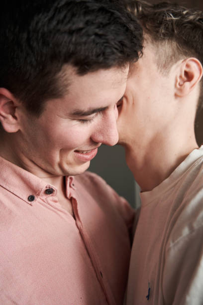 istock Man kissing his boyfriend while spending time together at home 1312650574