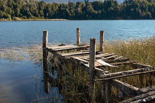 old abandoned dock next to lake in patagonia argentina.