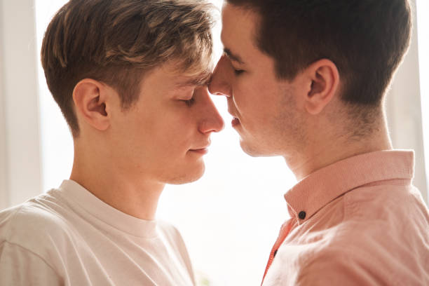 istock Boy keeping his eyes closed while standing at the kitchen with his boyfriend 1312651713