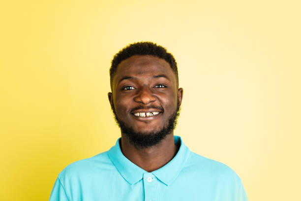 istock Portrait of young African man isolated over yellow studio background with copyspace. 1312652332