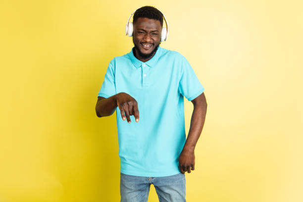 istock Young African man in headphones isolated over yellow studio background with copyspace. 1312652857