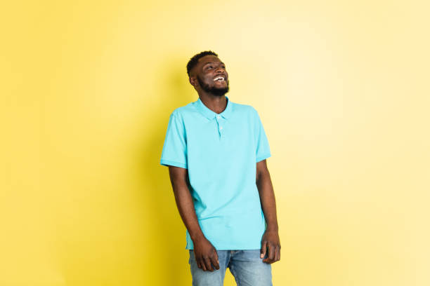 istock Portrait of young African man isolated over yellow studio background with copyspace. 1312652859