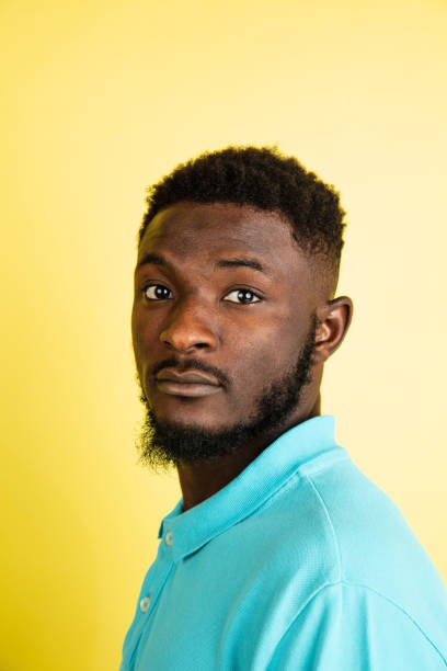 istock Portrait of young African man isolated over yellow studio background with copyspace. 1312652880
