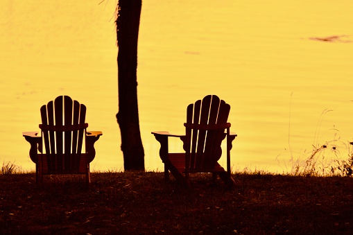 Adirondack chairs facing view in Silhouette background