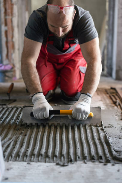 istock Man applying tile adhesive on the floor 1312654837