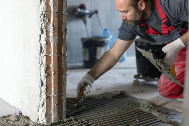 istock Man applying tile adhesive on the floor 1312654840