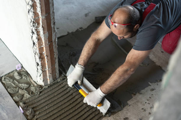 istock Man applying tile adhesive on the floor 1312654843