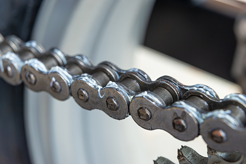 Metal drive chain of a motorcycle, close up shot.