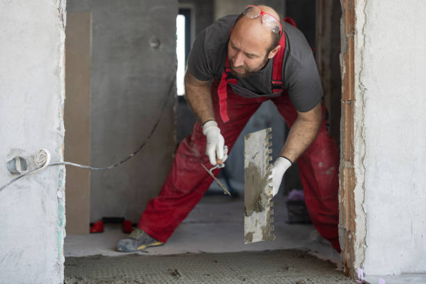 istock Man applying tile adhesive on the floor 1312656280