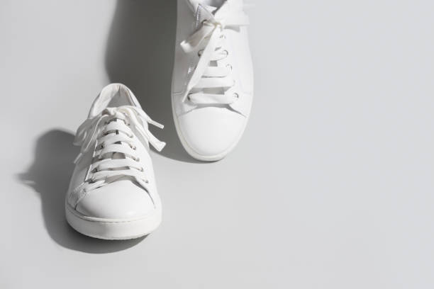 istock White female gumshoes on grey background. 1312657558