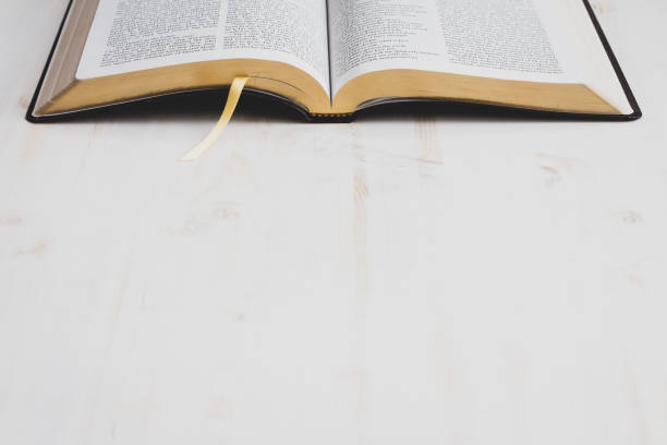 Open bible on white wood