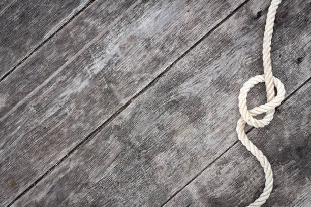 istock Border of rope knot on rustic wood 1312660407