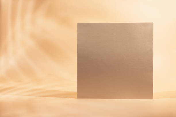 istock Gold Paper sheet or blank card with realistic leaf shadows 1312660772