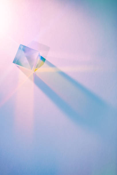 Glass cube with color spectrum rays. Glass cube with color spectrum rays. Abstract background with reflection and refraction of light. Shadow and rays of natural light effects. prism photos stock pictures, royalty-free photos & images