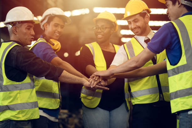 istock Engineer Teamwork Concept,Worker team join hands together in factory. People joining for cooperation success business of engineering partnership agreement of Architect engineer contractor mix race 1312662768