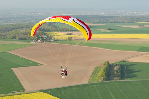 istock Colorful Paramotor seen from the sky over the fields of yellow rapeseed in spring 1312663004