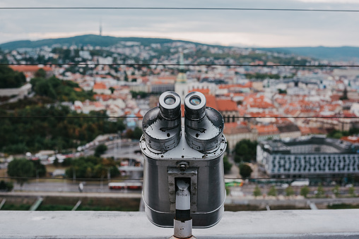 Old tower viewer binoculars and the city of Bratislava in the background
