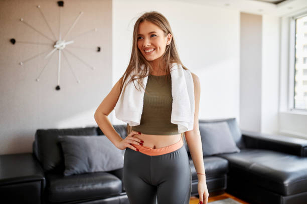 istock Young woman doing home workout in living room 1312668007