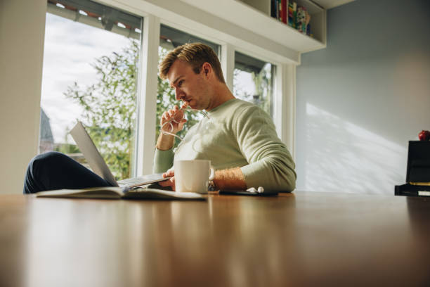 istock Man looking at his laptop and thinking 1312668071
